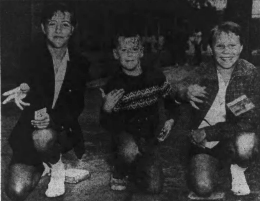 "PITCHING CARDS---TRADITIONAL PASTIME Caught right in the middle of this card pitching session at the 112th St. Park playground is Peter Malligan, nine years—who doesn't appear at all awed by the competition.  At left is Marlyn LaPlante, 14, and Louise Kruchesky, 14, is at the right." Albany Times-Union. September 2, 1956: T6 cols 5-7. (Times-Union Staff Photo) (from scan by fultonhistory.com)