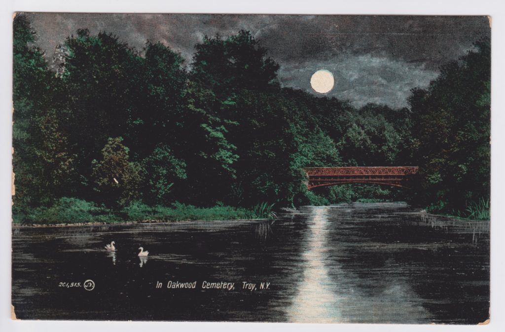 Color depicting of night scene on Oakwood Cemetery's round lake or "Ullswater" crossed by metal bridge