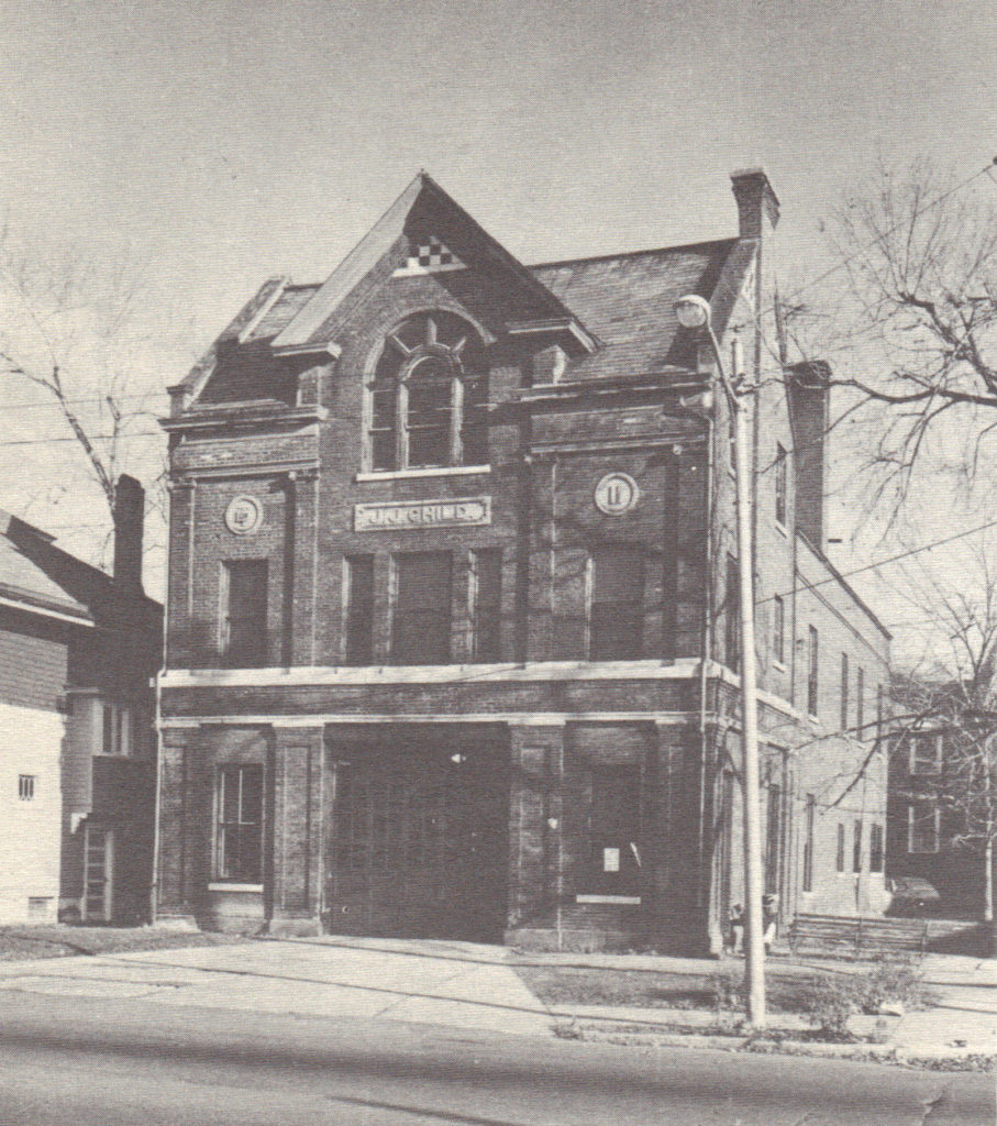 Black and white photograph of facade and south side of former JJ Child Steamer Company building